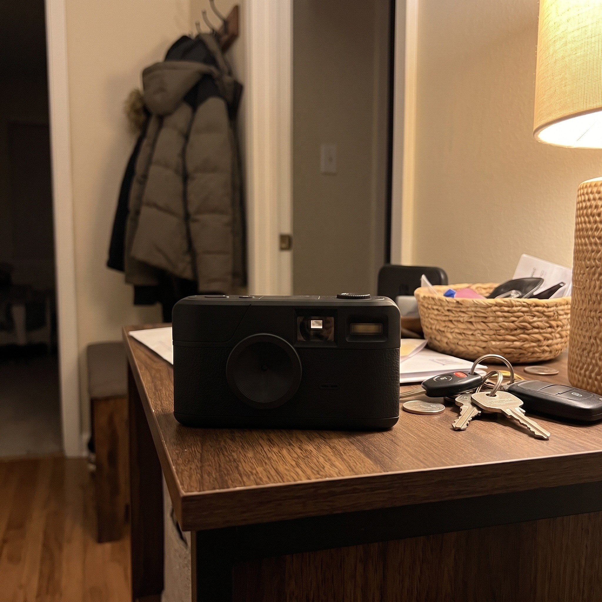 Black camera resting on a hallway shelf