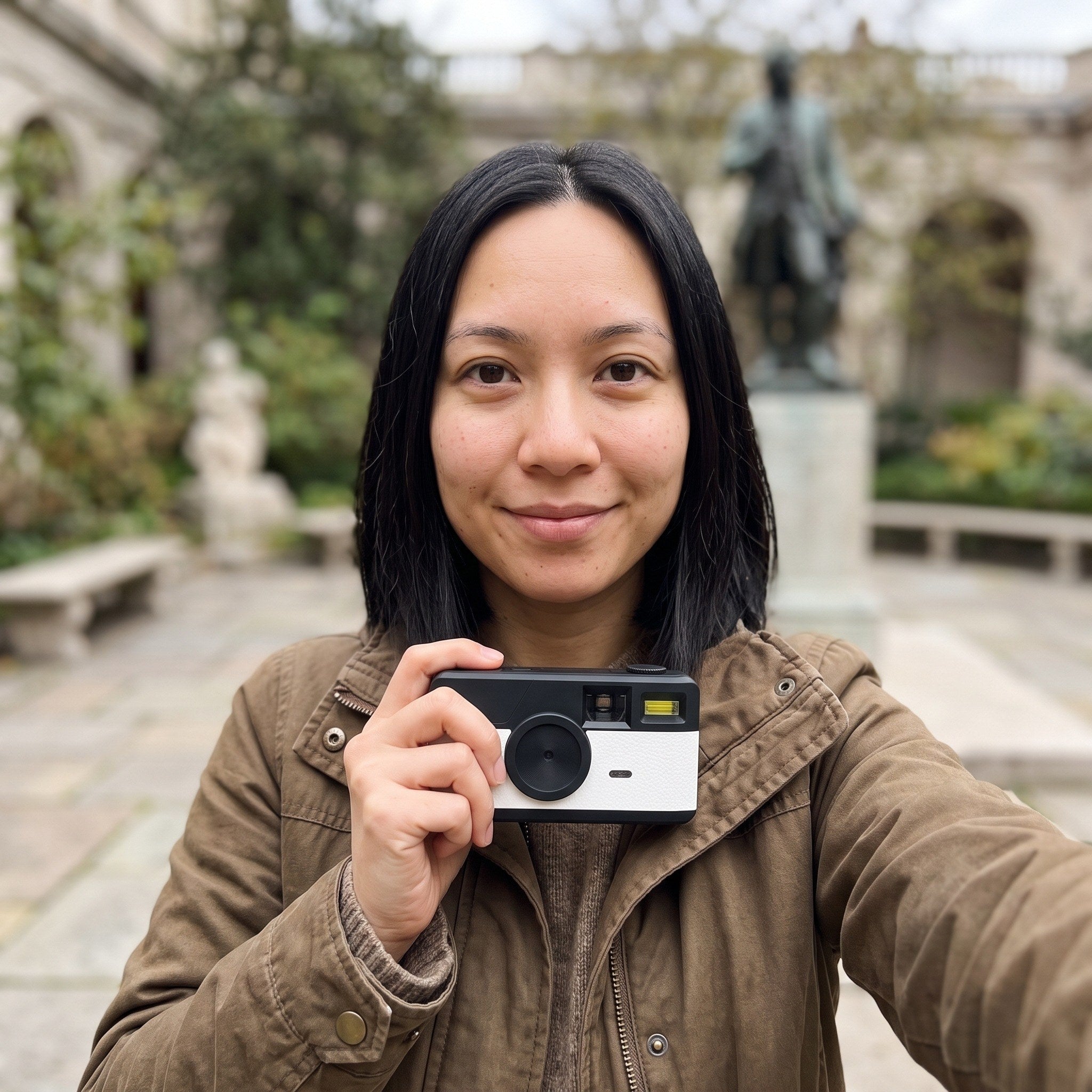 Sophie with her camera in a museum courtyard